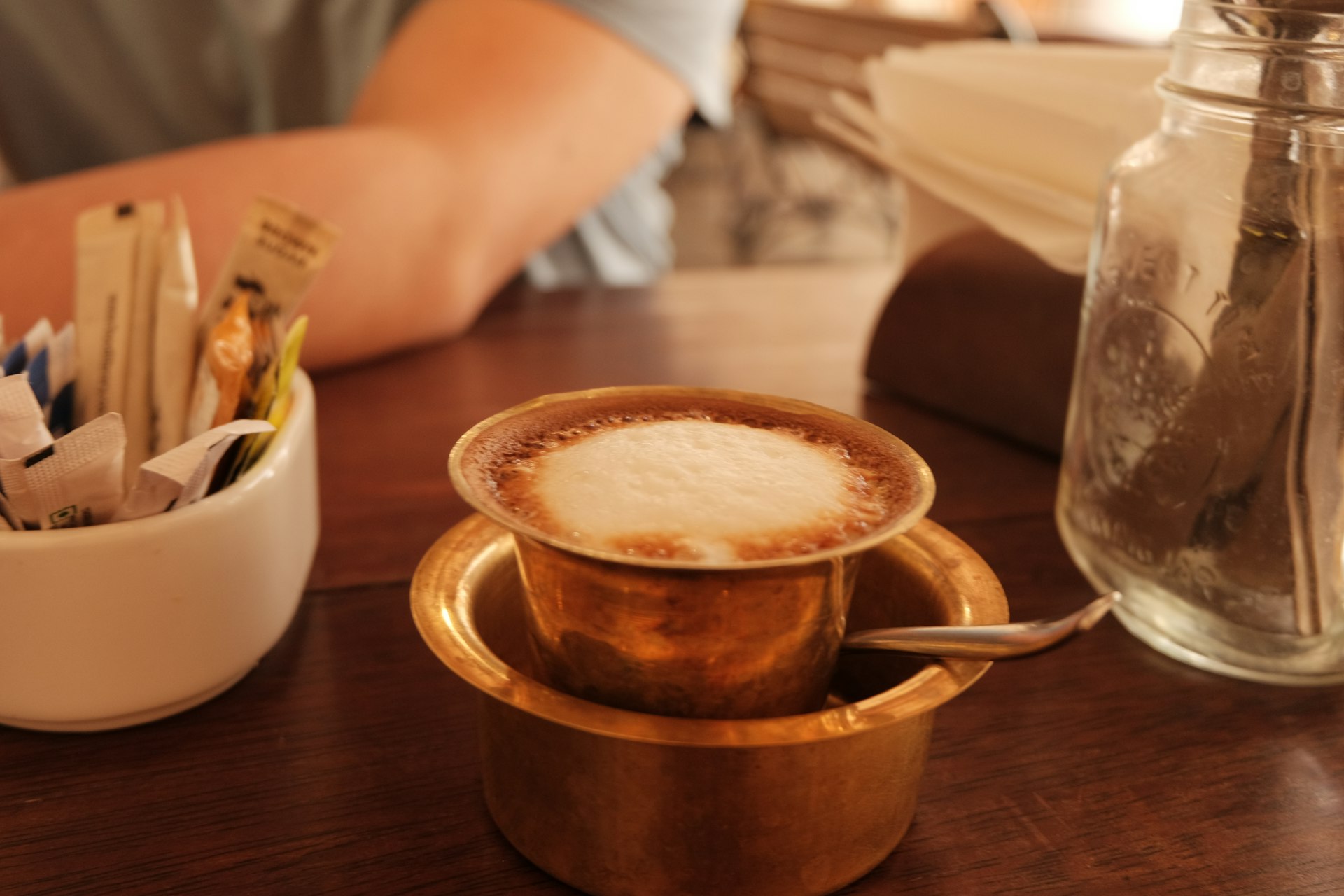 a cup of cappuccino on a wooden table